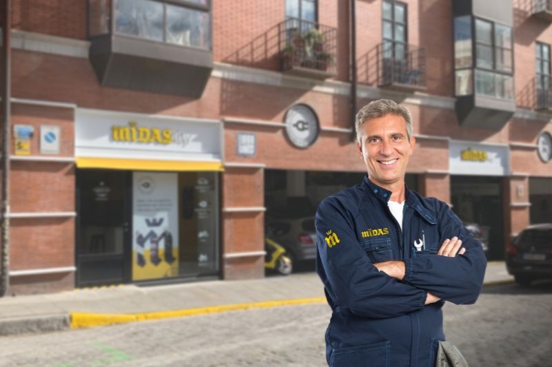 Un mecánico enfrente de su taller Midas.